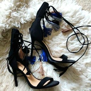 Black stilettos with tie-up strings and tassels